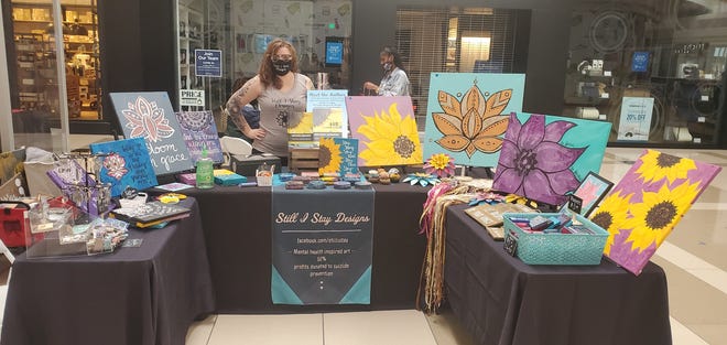 Vicky Mennare sells her acrylic paintings at pop-up shops throughout Greater Lansing. Her business, "Still I Stay," donates 50% of its profits to suicide prevention.